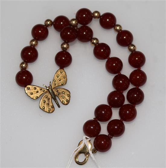 A 9ct gold and carnelian bead and butterfly necklace, 15in.